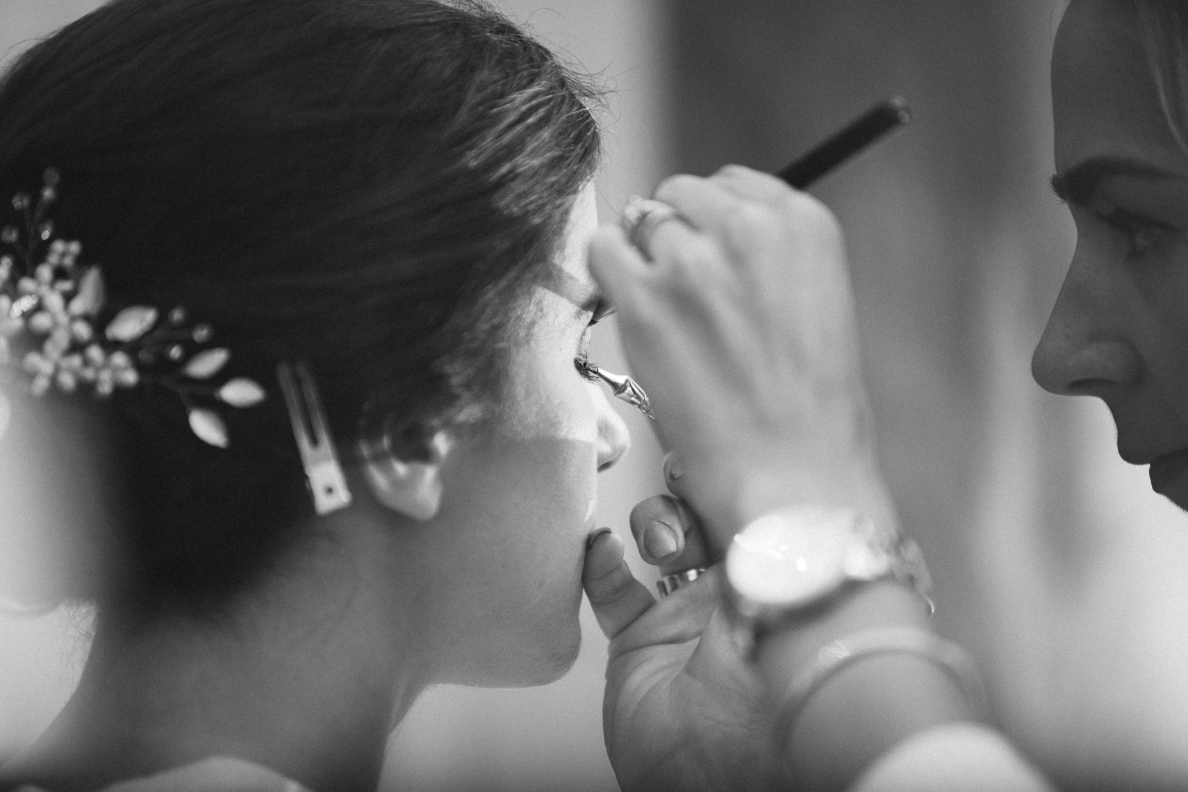Bride with makeup artist on wedding day
