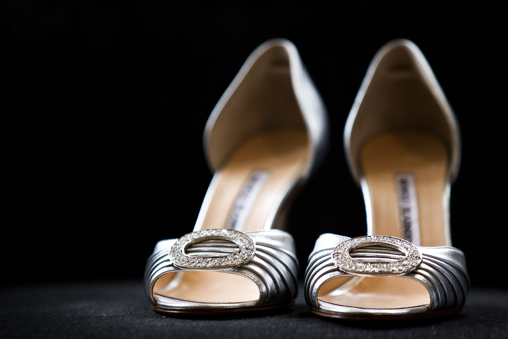 Silver bridal shoes on a black background